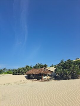 A simple thatched shade on the beach for storing boats