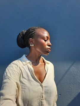 A young African woman taking a side profile selfie