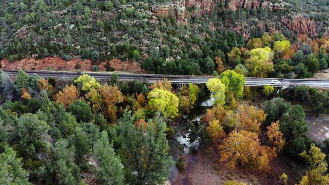Aerial view over the East Verde River with a highway bridge running over it in rural Arizona.