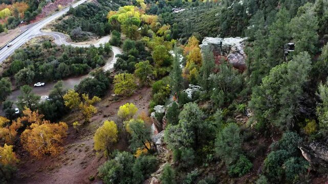 Drone shot over Sycamore Creek surrounded by trees and highway 282 in rural Arizona.