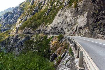 Fototapeta premium A mountain road winds along a rugged cliff, Montenegro