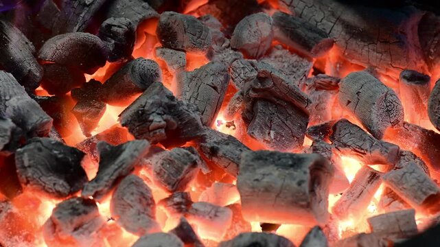 Glowing hot charcoal briquettes burning in barbecue grill