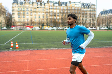 Obraz premium Young black man running track in paris city