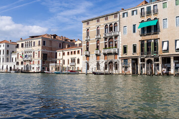Naklejka premium Photo of the beautiful city of Venice in Italy showing a view of the historical buildings with boats tied up under the houses located on the famous Italian canals on a sunny summers day