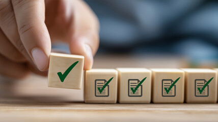 Hand putting wooden cube with green check mark symbol on document files symbolizing approval process