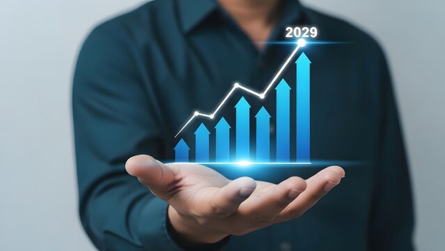 Businessman holding futuristic growth chart with 2029 displayed on the screen