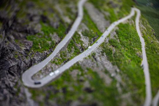 Tilt shift miniature effect. Mountain serpentine road Trollstigen in Norwegian valley.