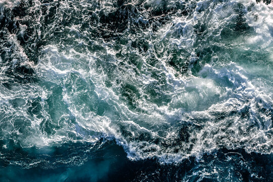 Blue waves of water of the river and the sea meet each other during high tide and low tide.