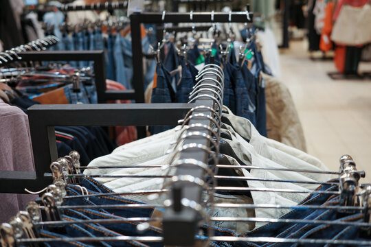 Hangers with clothes in the store.