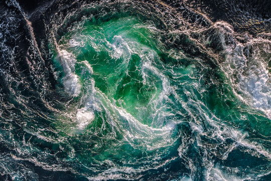 Blue waves of water of the river and the sea meet each other during high tide and low tide.