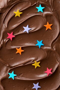 Chocolate hazelnut spread with colorful stars sprinkles. Full frame pattern. Top view