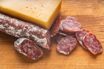 dried sausage and cheese on a wooden kitchen board