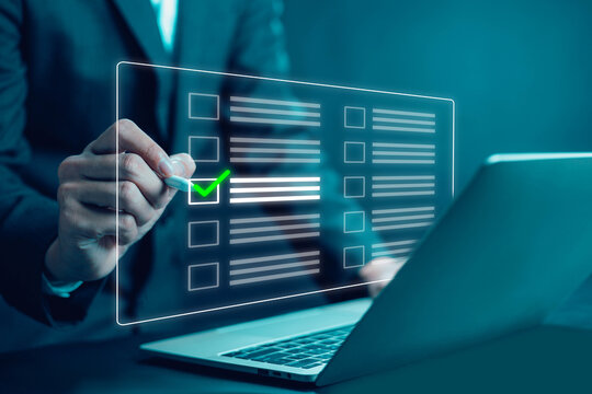 Business professional checking digital checklist with green check mark on virtual interface representing approval process task completion, compliance verification quality control, audit, and workflow. - Powered by Adobe