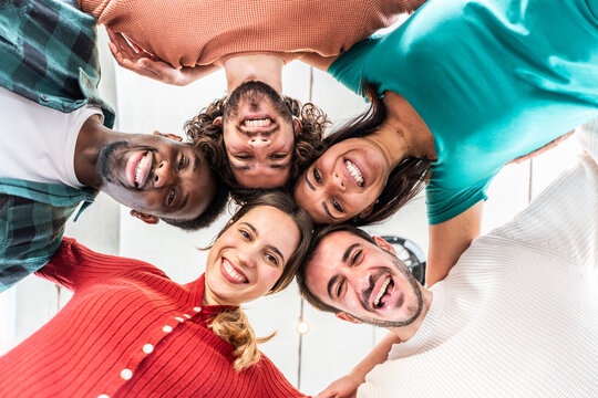Portrait close up picture of happy faces young friends standing in circle and looking at camera - Millenial diverse people taking selfie photo - Life style concept with guys and girls hugging together