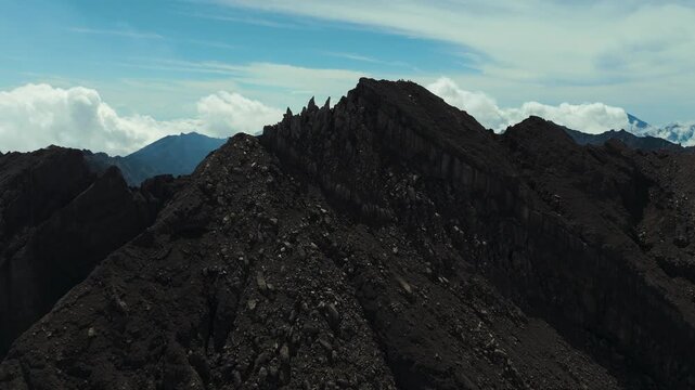 4K drone footage of Mount Raung at sunrise, revealing steep ridges, misty forests, and one of Indonesia&rsquo;s most extreme hiking trails with cloud and vulcano 