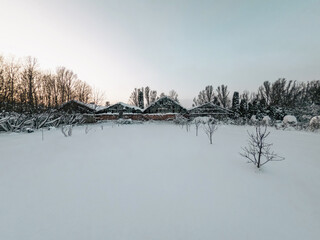 Winter landscape, trees, buildings. Field covered with snow, sunset. Soothing winter screensaver.