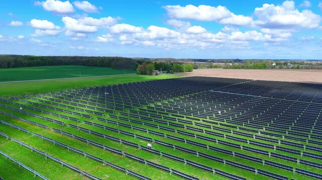 Expansive Blue elk solar farm generating sustainable and clean energy under a blue sky in Adrian, Michigan, USA