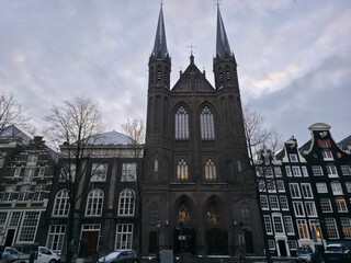 View of Neo-Gothic De Krijtberg church (St. Francis Xavier Church) on Amsterdam's Singel canal during winter
