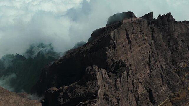 4K drone footage of Mount Raung at sunrise, revealing steep ridges, misty forests, and one of Indonesia&rsquo;s most extreme hiking trails with cloud and vulcano 