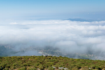View from the mountain with the city under clouds. Alto da Groba - Baiona - Spain