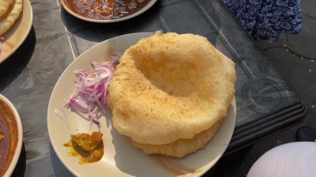 Soft and fluffy bhatura served with chola. 
