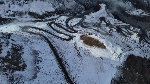 Switchback Road On Snow Covered Mountain Pass Aerial View