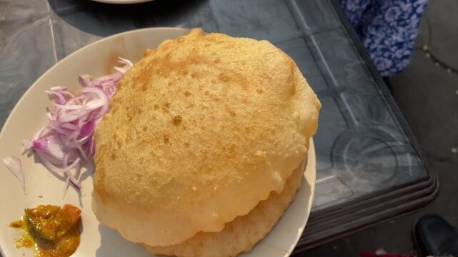 Soft and fluffy bhatura served with chola. 