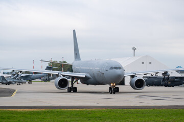 A330 Multinational Multi Role Tanker Transport fleet on the ground at an airbase with support aircraft nearby