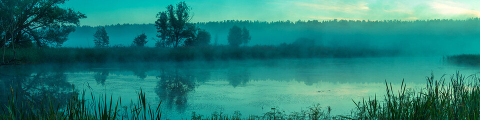 Foggy morning. Lake before sunrise. Rural landscape, mystical feeling