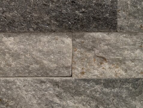 stone wall surface, textured grey stone wall with clean horizontal alignment and soft color tones