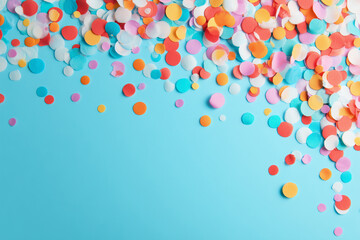 Colorful confetti scattered on a blue background for festive occasions