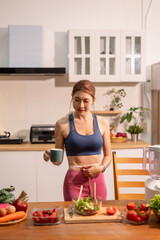 Fit woman enjoys healthy fruit breakfast after yoga training. fitness, nutrition, home lifestyle.