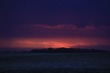 A Prairie storm clouds and setting sun. 