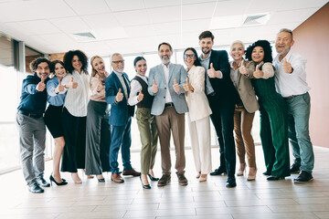 Confident diverse professionals posing as a cohesive team in a clean modern office space.