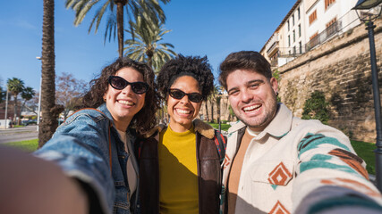 Happy friends taking a selfie on urban street