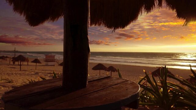 Cinematic Golden Hour View of a Tropical Beach through a Traditional Thatched Palapa. traditional thatched palapa. The golden sun dips toward the horizon, travel agencies, hospitality marketing conce 