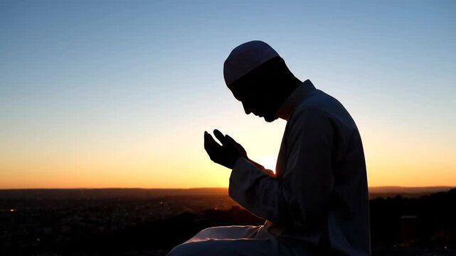 Man praying in contemplation at serene sunset landscape with flowing robes and peaceful surroundings in high definition video
