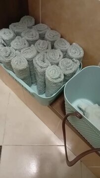 The towels are made of soft cotton, neatly folded in a basket in a public toilet. design of a modern toilet or bathroom. Vertical Video