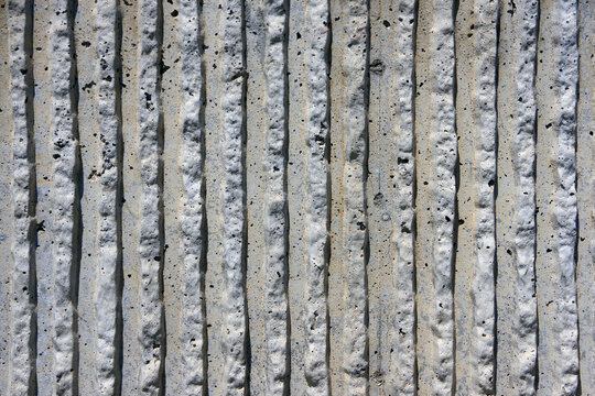 Concrete wall surface shaped in stripe pattern