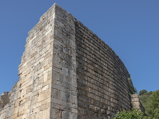 Ruins of the amphitheater in the city of Perge. An ancient city located in Turkey. The walls of the amphitheater in the ancient city are made of huge stone blocks. Masonry of ancient buildings.