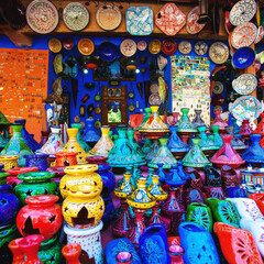 Colored Tajine, plates and pots out of clay on the market of Chefchaouen in Morocco, green, blue, red