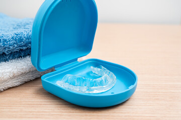 Close-up of invisible aligners for dental correction in a box at bathroom.