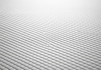 Naklejka premium Closeup of white quilted fabric texture with diagonal stitching pattern, abstract background