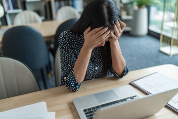 Burnout concept. Asian Business woman touching forehead having headache boring job and tired emotional pain and professional person depressed over risk