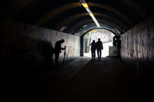 Photographer And A Couple In A Tunnel