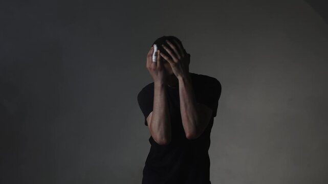 A young male rock vocalist screams aggressively into the camera, his face contorted with destructive emotion. Motion blur emphasizes unstable emotional intensity.