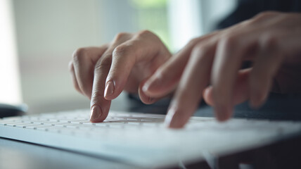 Closeup, business woman hand typing on desktop computer keyboard, online working, searching the...