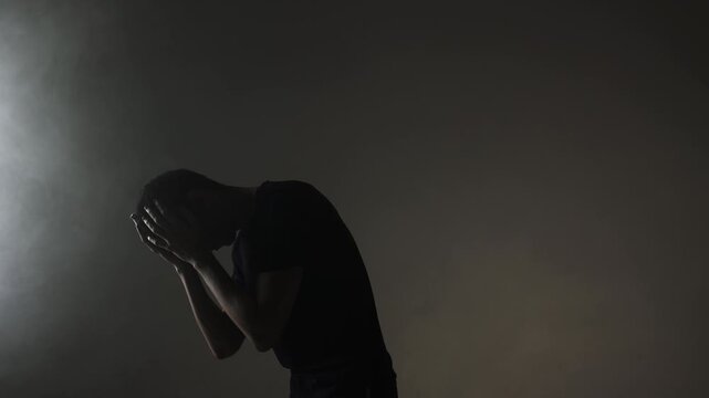 A young male rock vocalist screams aggressively into the camera, his face contorted with destructive emotion. Motion blur emphasizes unstable emotional intensity.