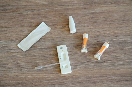 Pregnancy test with positive result on wooden table background, top view