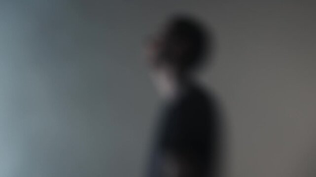 A rock vocalist in the midst of a destructive emotional outburst, screaming directly at the lens. Motion blur captures his unstable, frenzied state.